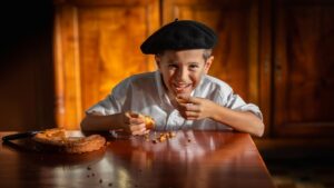 Photo enfant avec le sourire mangeant un gateau absque
